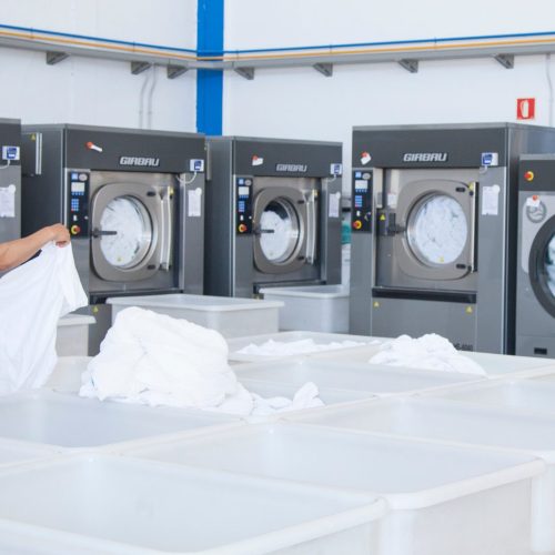 many industrial laundry maschines in a room